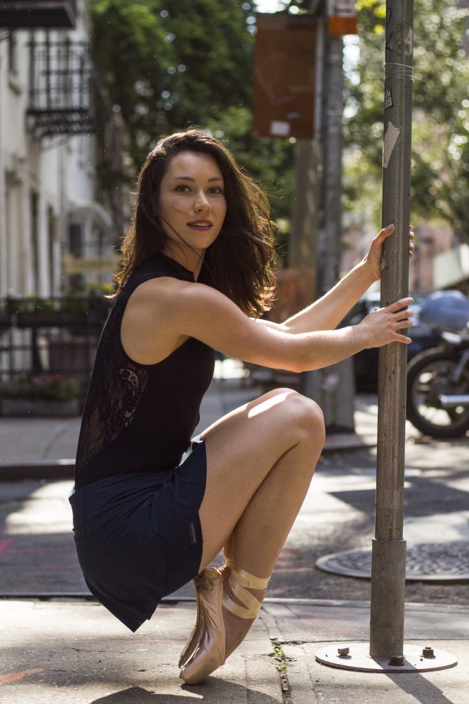 Courtney Echols on pointe looking at the camera with hair blowing